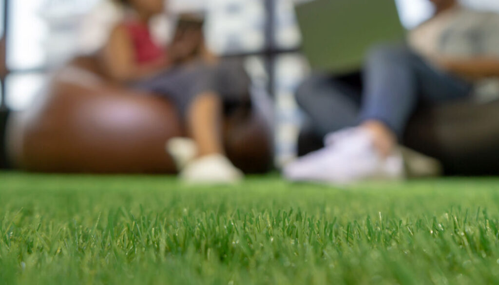 People-sitting-on-artificial-turff