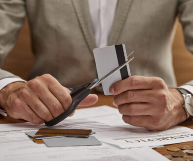 Man cutting up credit cards