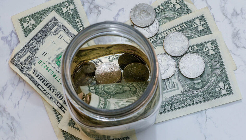 Lookind down in a jar with money